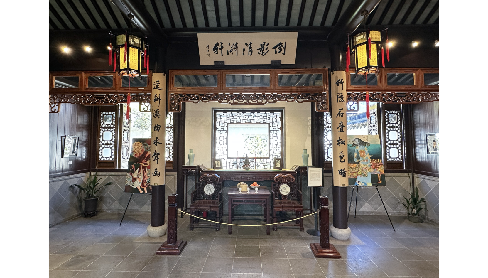 Photo of room with two columns on either side of shrine with two ceiling lanterns on either side