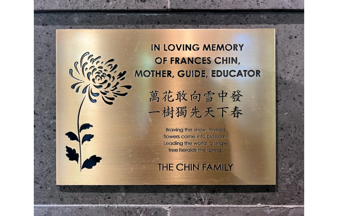 Photo of brass plaque with Chinese lettering and flower, honoring Frances Chin