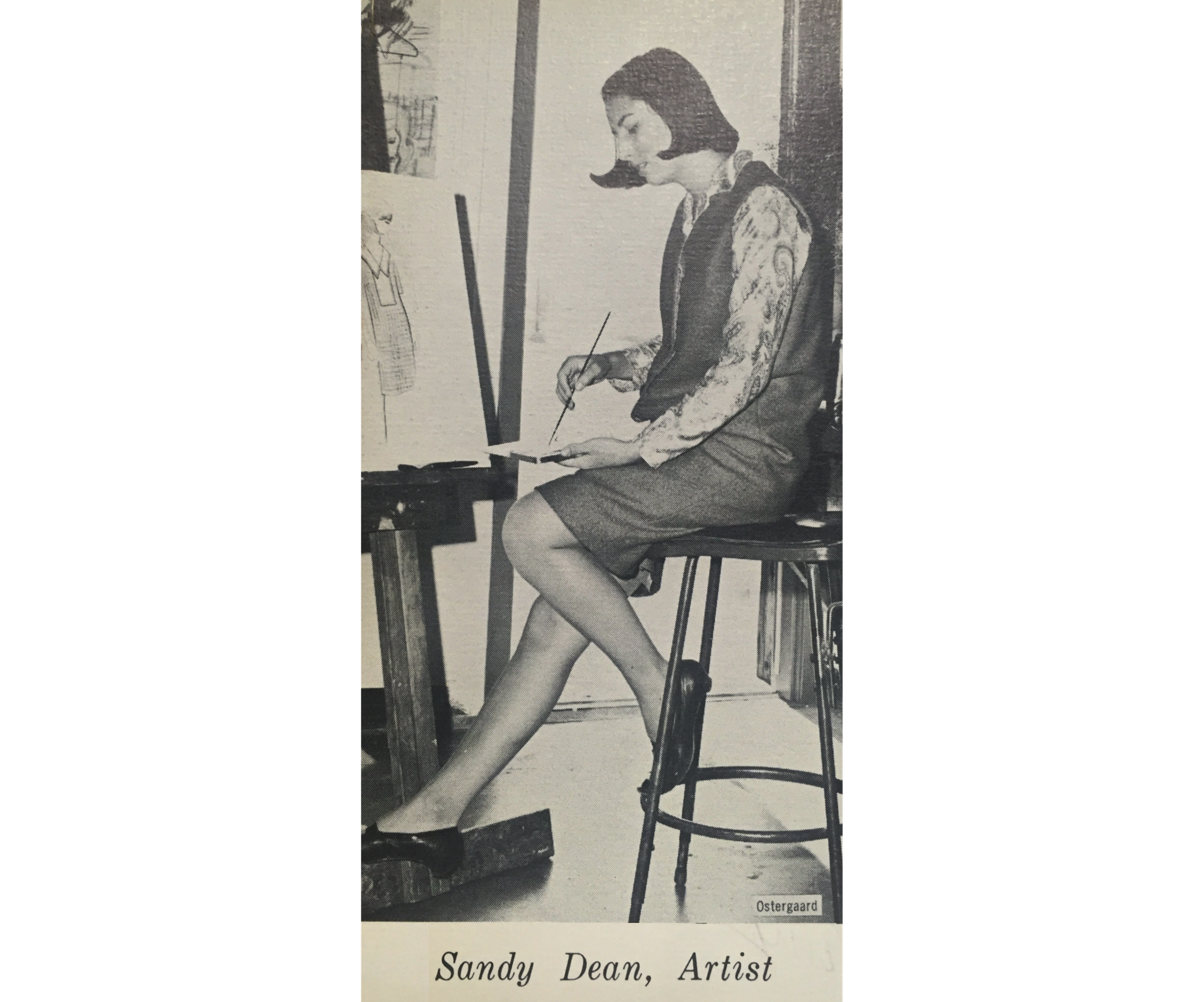 PHoto of Sandra Dean as a senior in high school, sitting on a school facing left painting on an easel