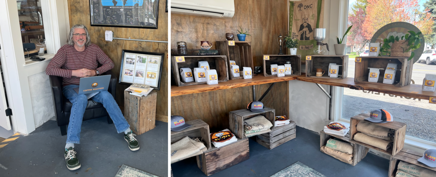 A man sits in a chair holding an El Jefe Coffee Roasters laptop, beside a retail display of El Jefe coffee bags, branded hats, and burlap merchandise arranged on rustic wooden crates and shelves.