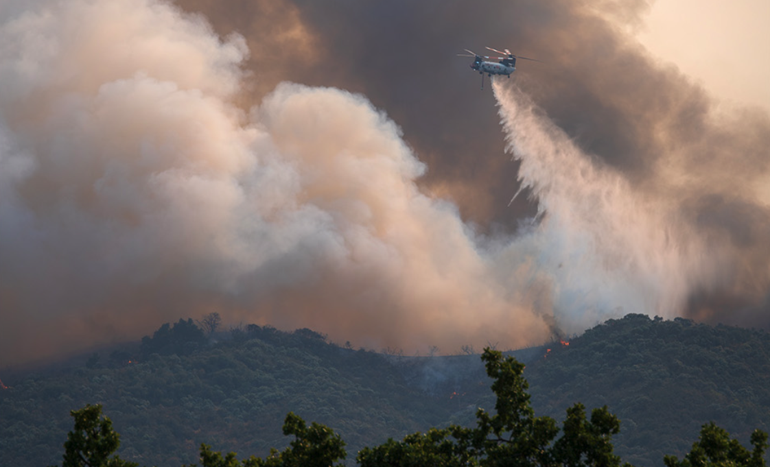 Wildfire burning across dry California hillside vegetation during the 2026 fire season.