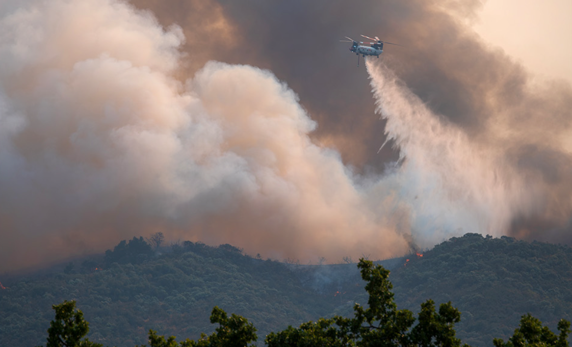 Wildfire burning across dry California hillside vegetation during the 2026 fire season.
