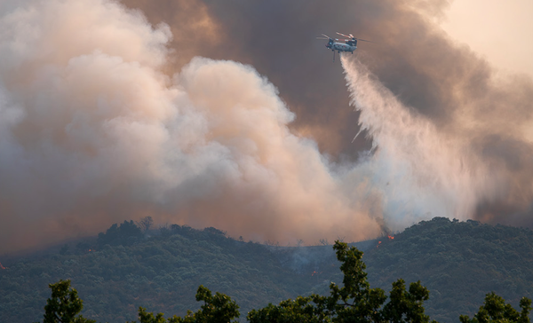 Wildfire burning across dry California hillside vegetation during the 2026 fire season.