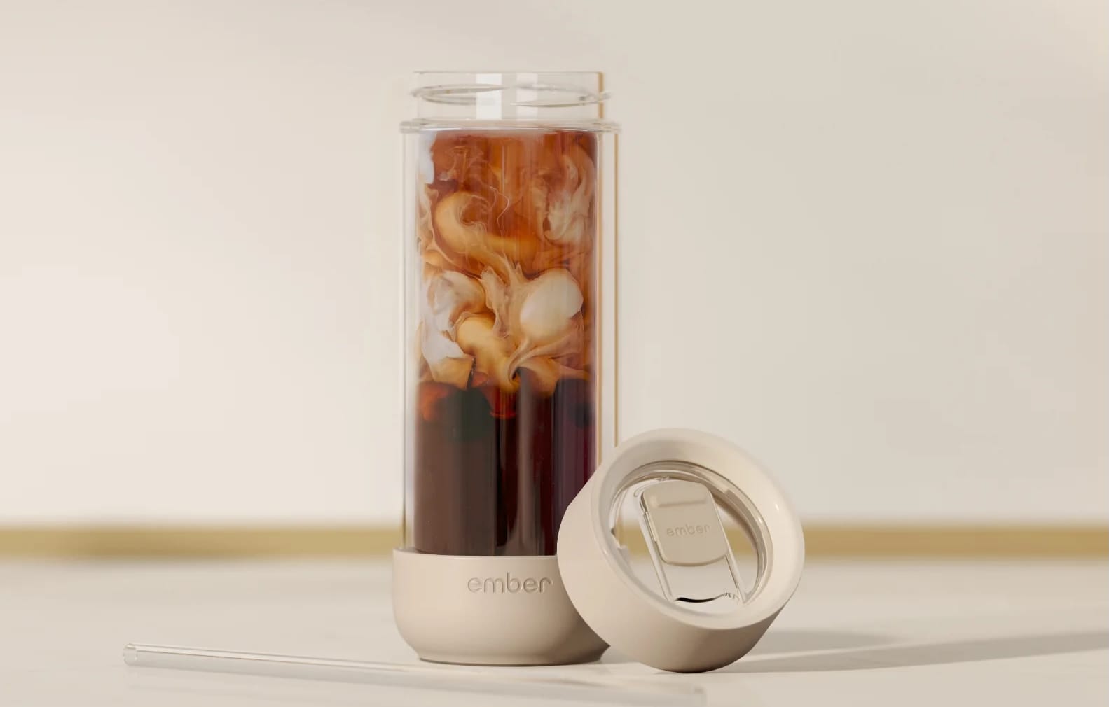 Ember Cold Tumbler on a table with coffee insider.