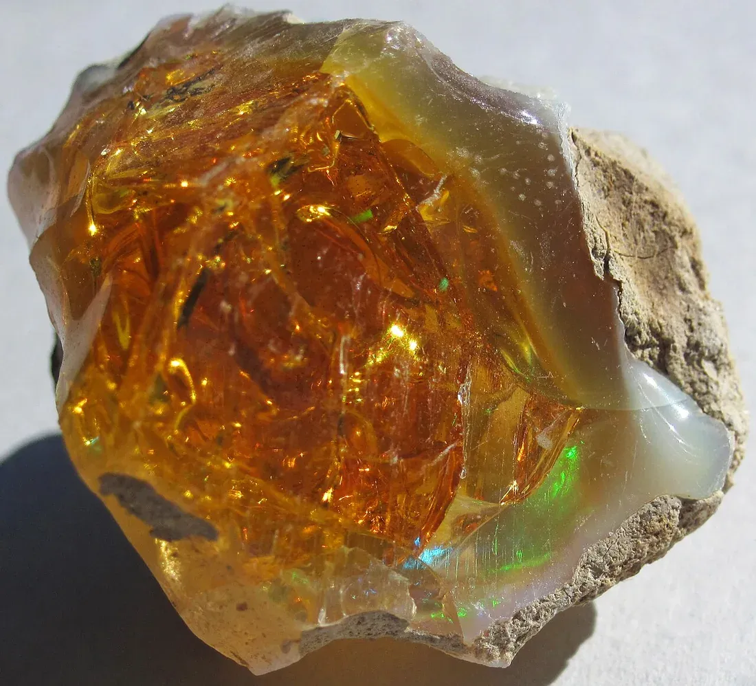 Macro photograph of precious opal from Berbere Hill, Ethiopia, showing green and blue play-of-colour