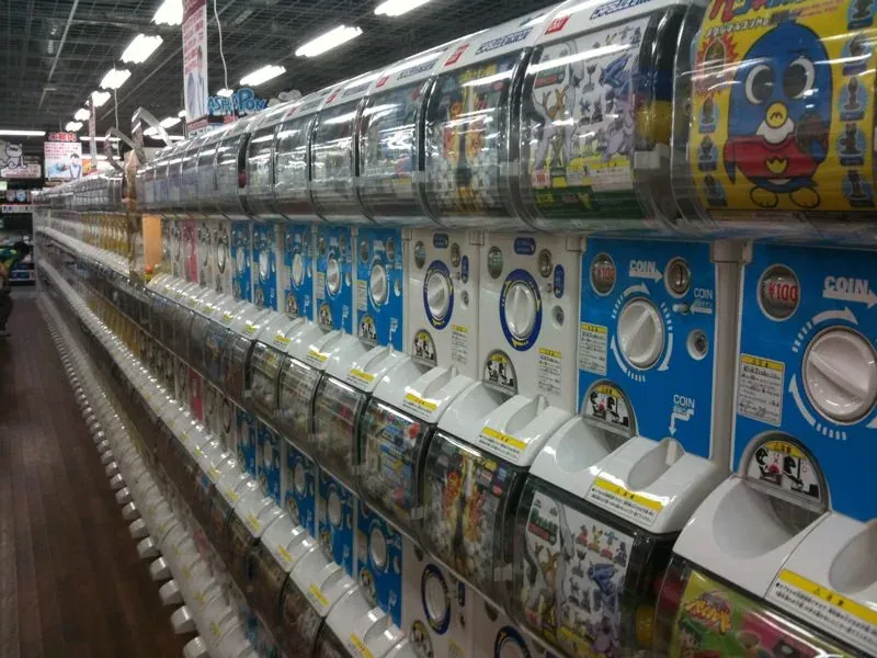 Wall of gachapon capsule toy vending machines in Akihabara, Tokyo, stacked in rows of bright colors