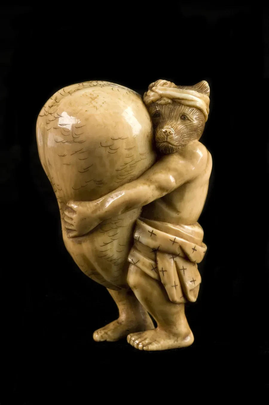 Carved ivory netsuke from Japan, 1701 to 1900, depicting a small figure, held in the Wellcome Collection