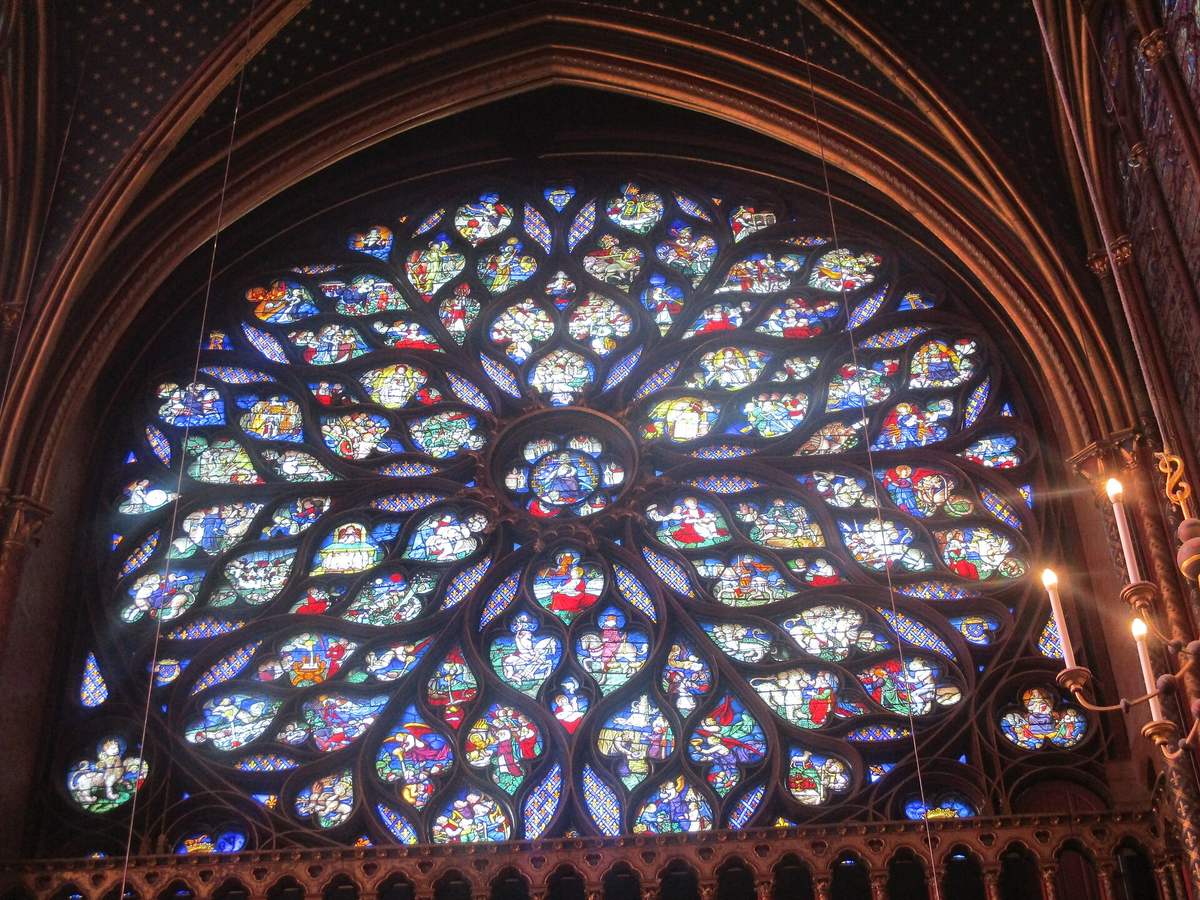 Gothic rose window of the Sainte-Chapelle in Paris, stained glass in deep blue and red