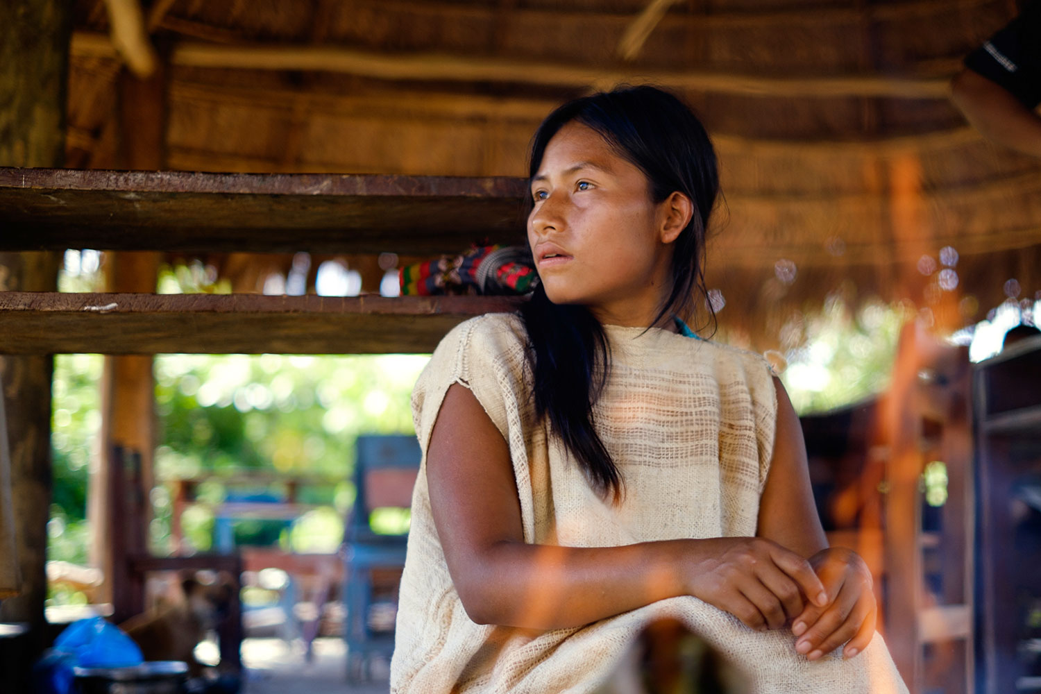 A young Matsigenka woman prepares a meal of Amazonian catfish steamed in bamboo shoots. She wears a traditional cushma while she works with her mother, but takes it off when she heads to the nearby schoolhouse for lessons. Photo: Kevin Floerke