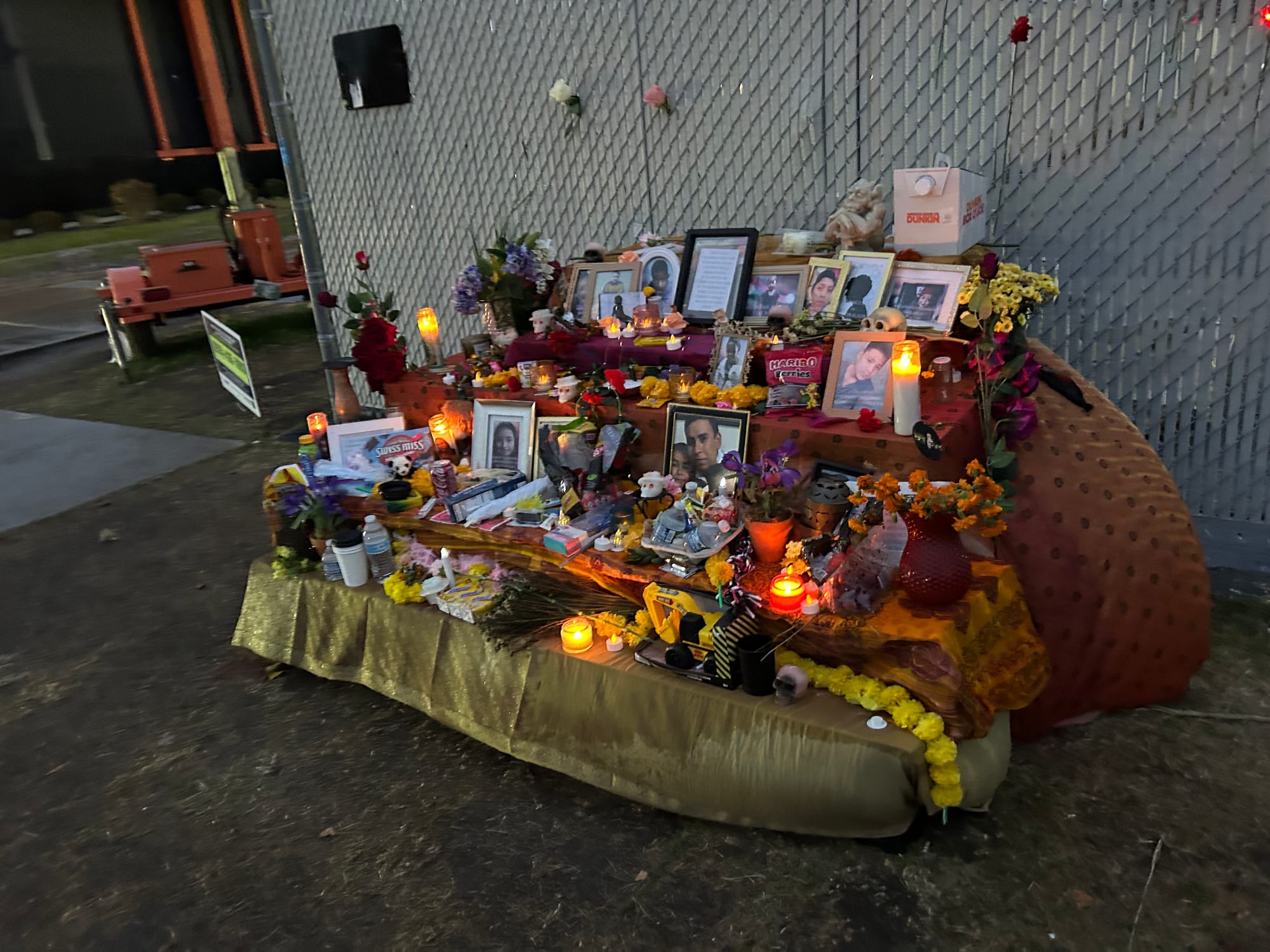 An Ofrenda at Broadview ICE with flowers, photos, toys and pictures of children lost in the DHS system.