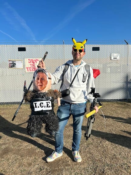 A protestor at Broadview ICE holds an actual-size dummy of Greg Bovino, an actual dummy
