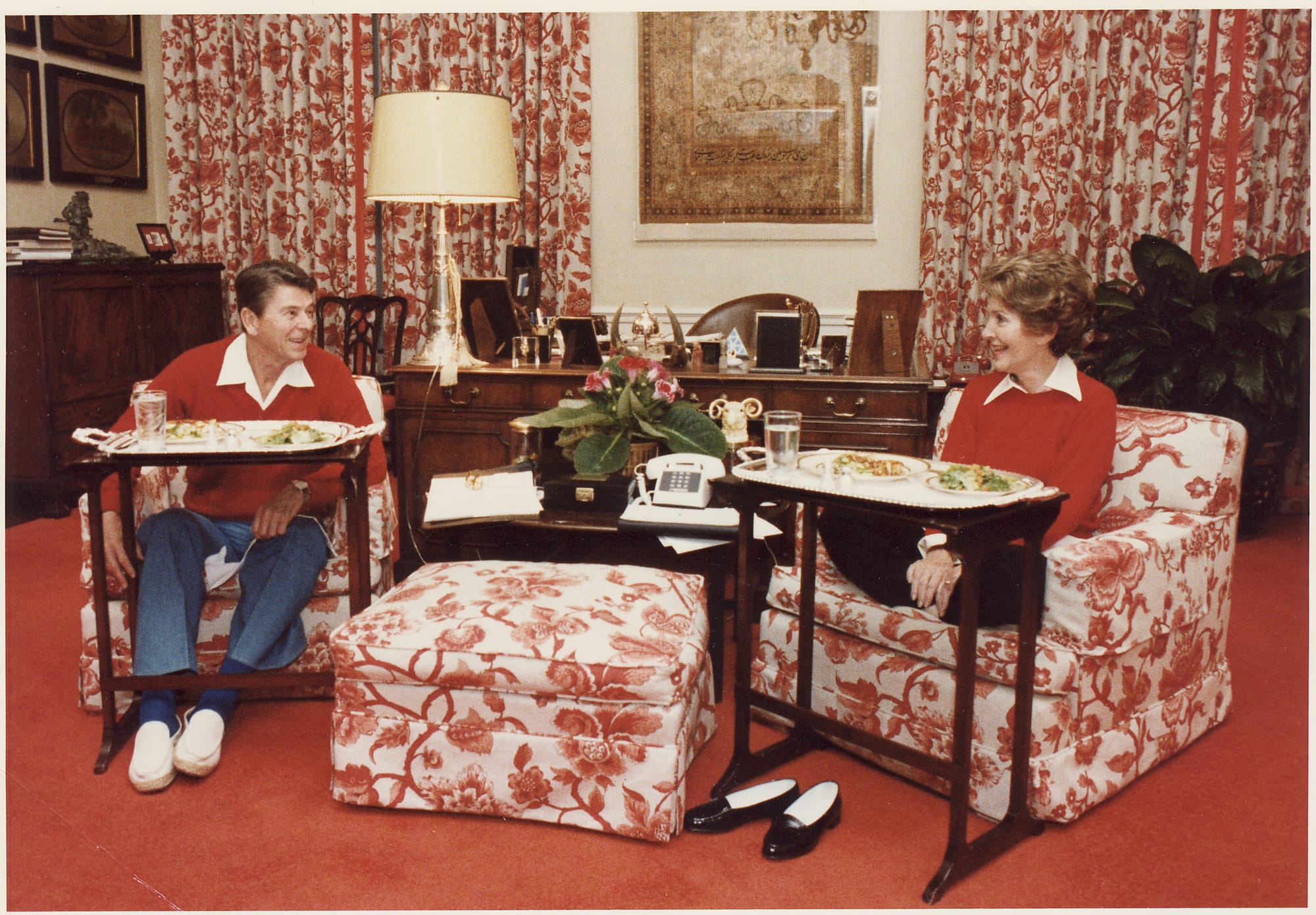 President and Mrs. Reagan eating dinner on TV trays in the White House residence, circa 1981. National Archives.
