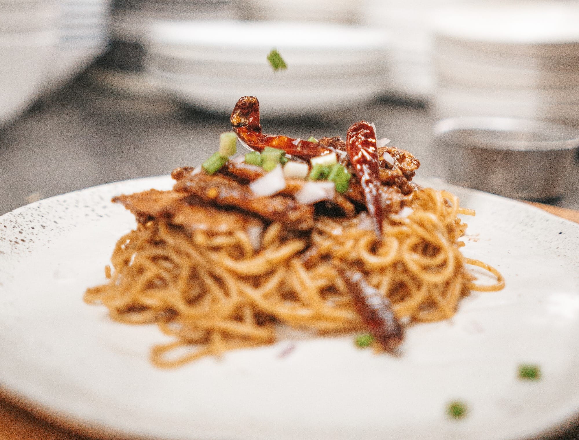 person holding white ceramic plate with food