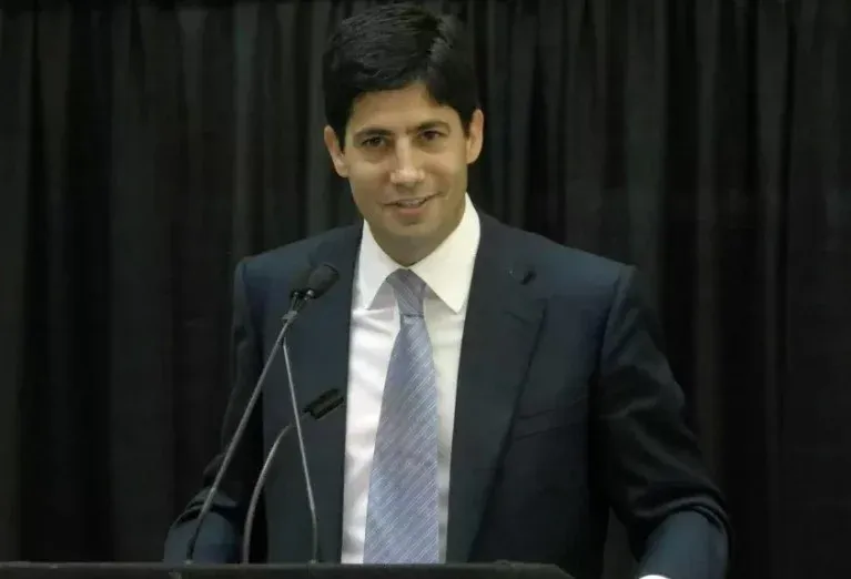 Retrato de Kevin Warsh con ícono de Bitcoin