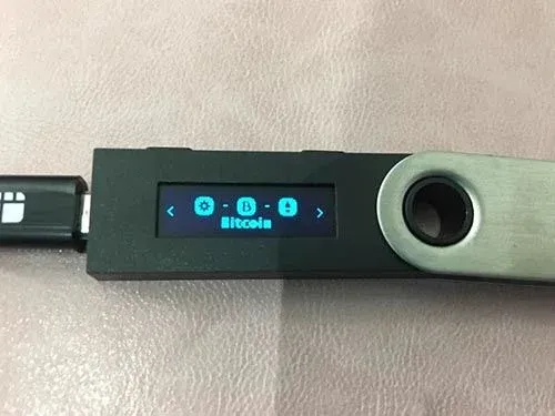 Ledger Nano S 屏幕显示 BTC 与 Bitcoin Cash 选项并按左右键