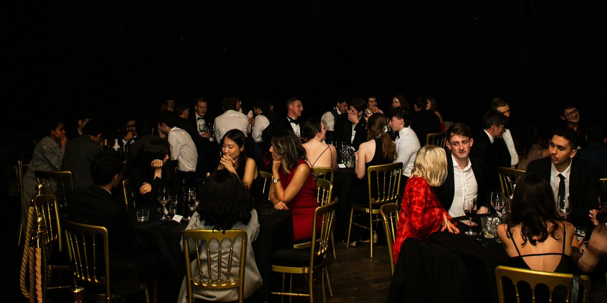 People dining at tables under a disco ball.