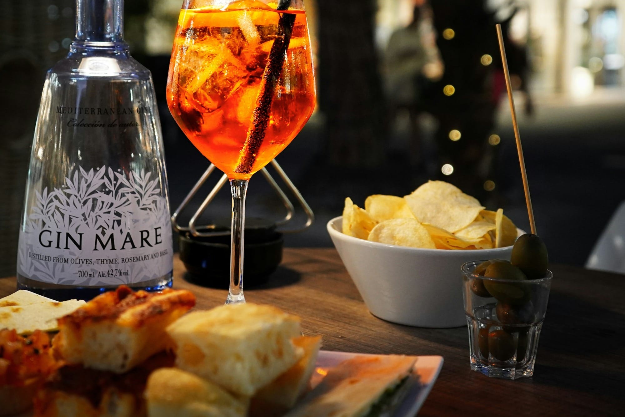 A table topped with a plate of food and a glass of wine