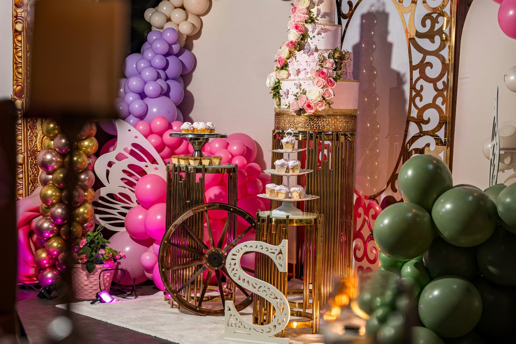 A festive party setup with balloons, cake, and decorations.