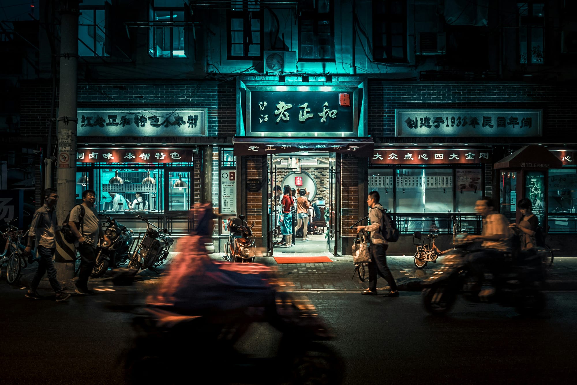 Bustling street scene at night in a Chinese city, representing authentic, ground-level immersion in Mandarin Unpeeled itineraries.