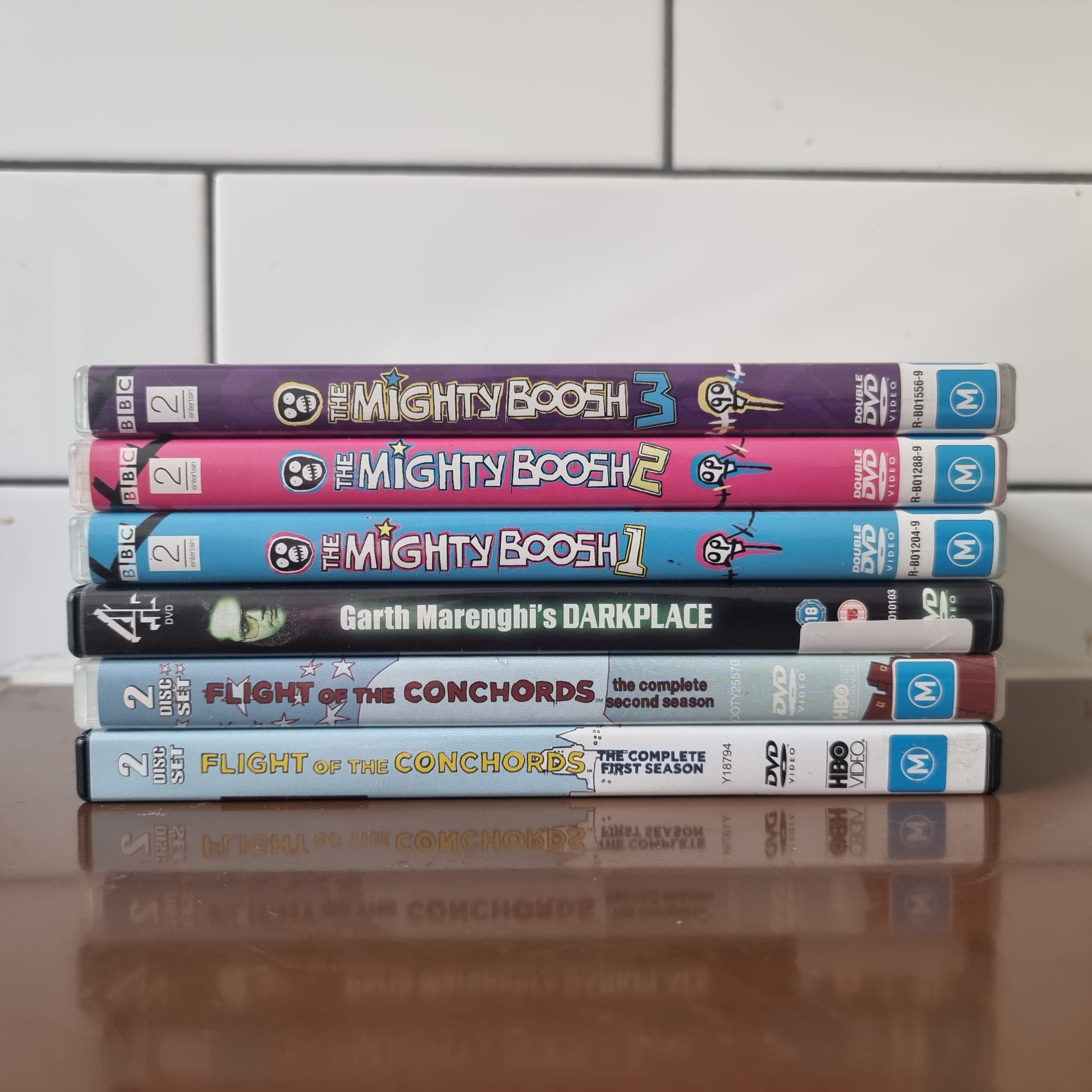 Another stack of DVDs. Flight of the Conchords 1 and 2, Garth Marenghi's Darkplace, and The Mighty Boosh 1 to 3.