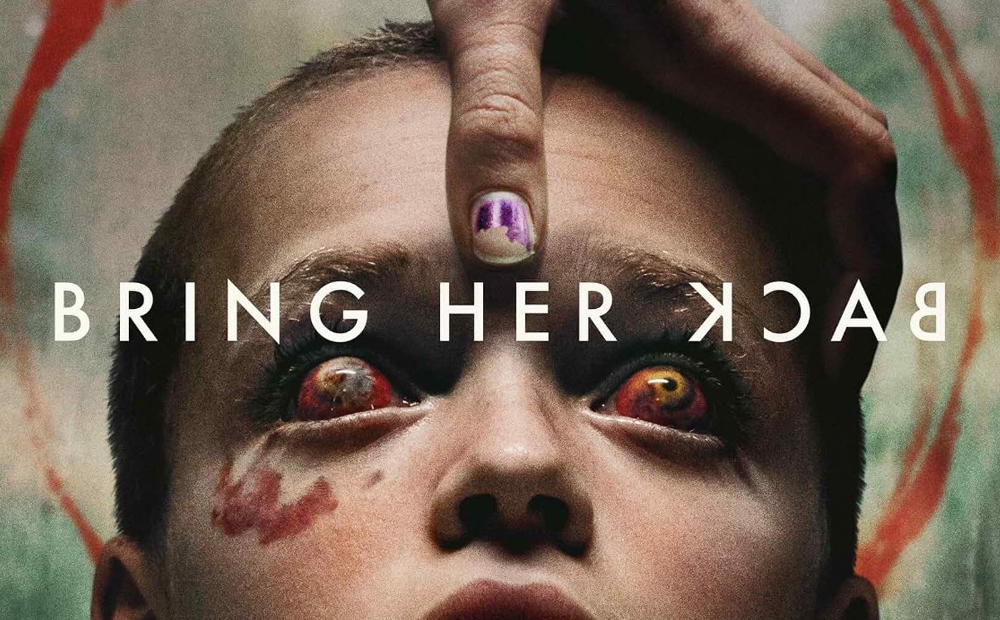 Poster for Bring Her Back. A child with bloody eyes is held down by a hand with chipped nail polish.
