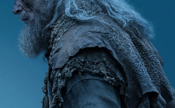 Cropped side profile of Hugh Jackman with long grey hair and beard