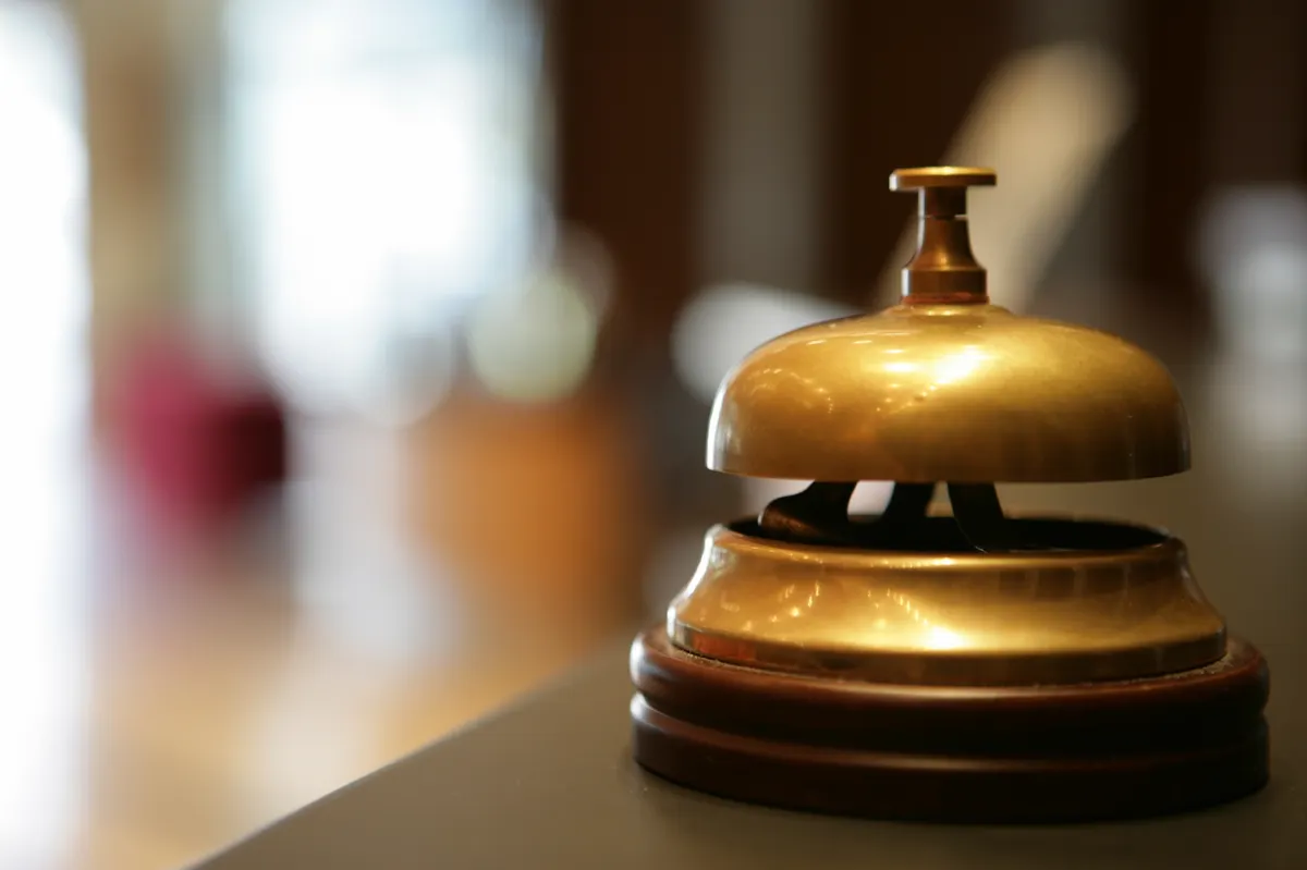 Close-up of a hotel reception bell on polished counter