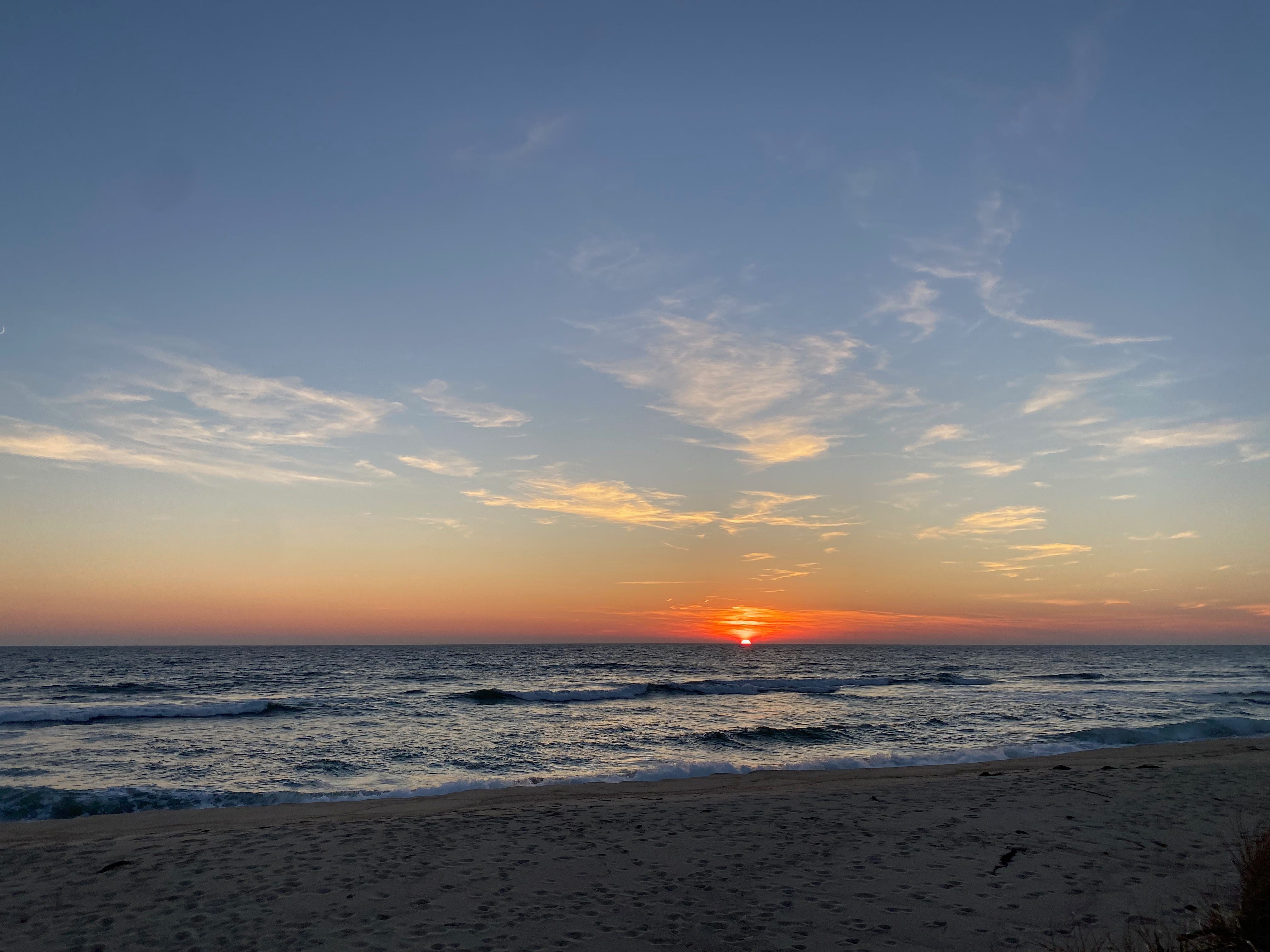 The sun setting over the ocean.