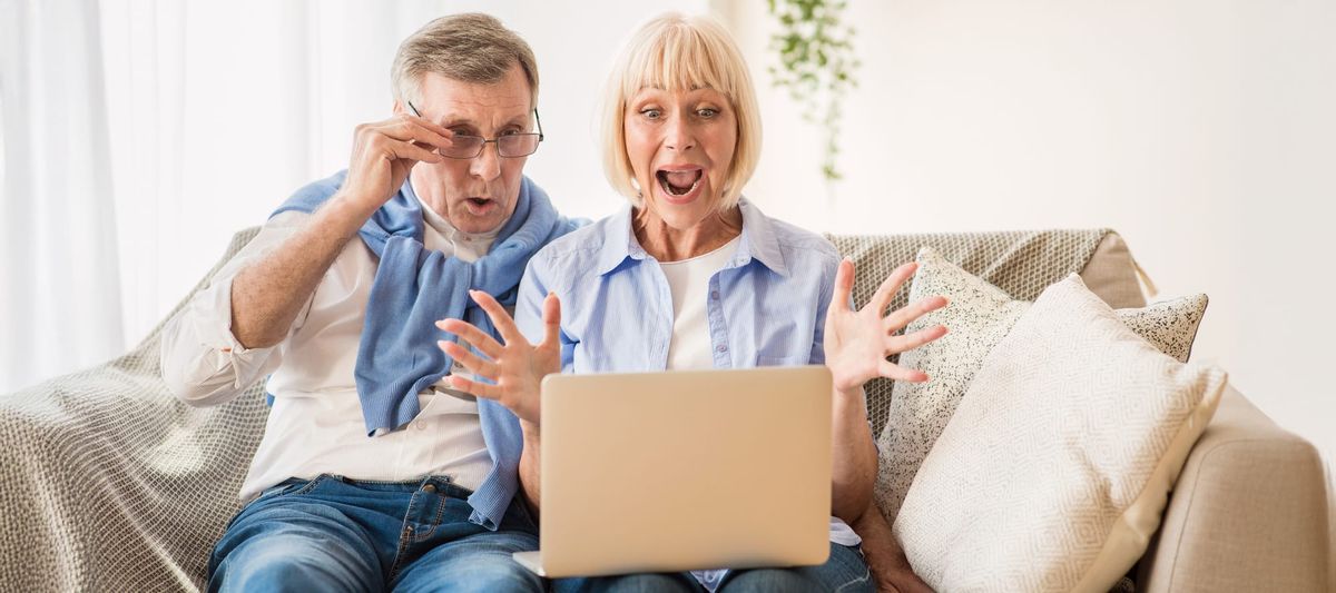 Surprised couple winning online auction bid. Guide to bidding in an online auction. How do I bid in an online auction?