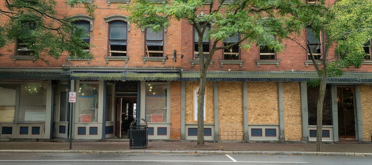 Storefronts of boarded up businesses that have gone out of business 