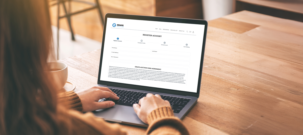 Person with long hair looking at Grafe Auction's registration page.