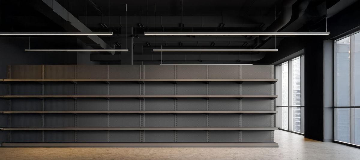 Empty shelves in gray supermarket