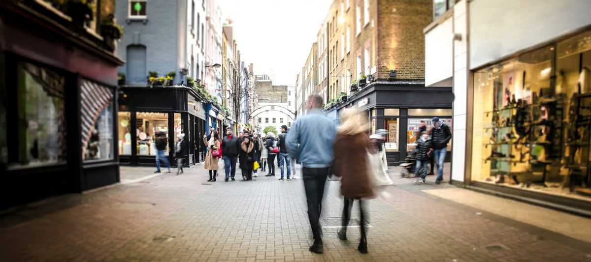 Motion blurred shoppers on retail street