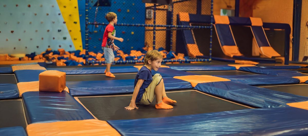 Boys jumping on trampoline in entertainment center, trampoline park, bounce houses, entertainment center, event cente