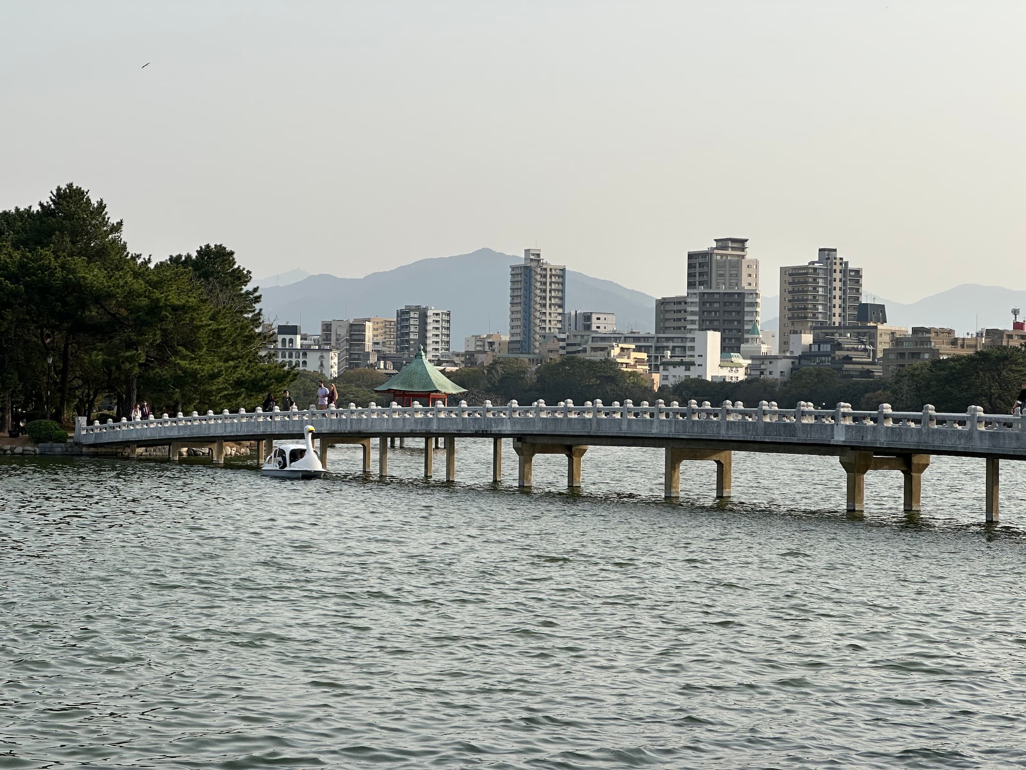 Ohori Park Fukuoka scene with mountains and buildings in the background