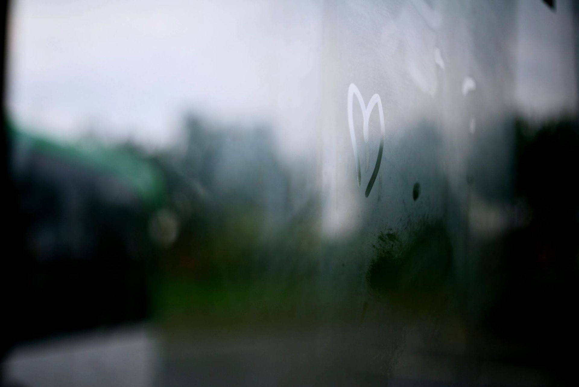 Photo of steamy window with a heart drawn by a fingertip on the glass.