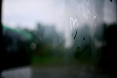 Photo of steamy window with a heart drawn by a fingertip on the glass.