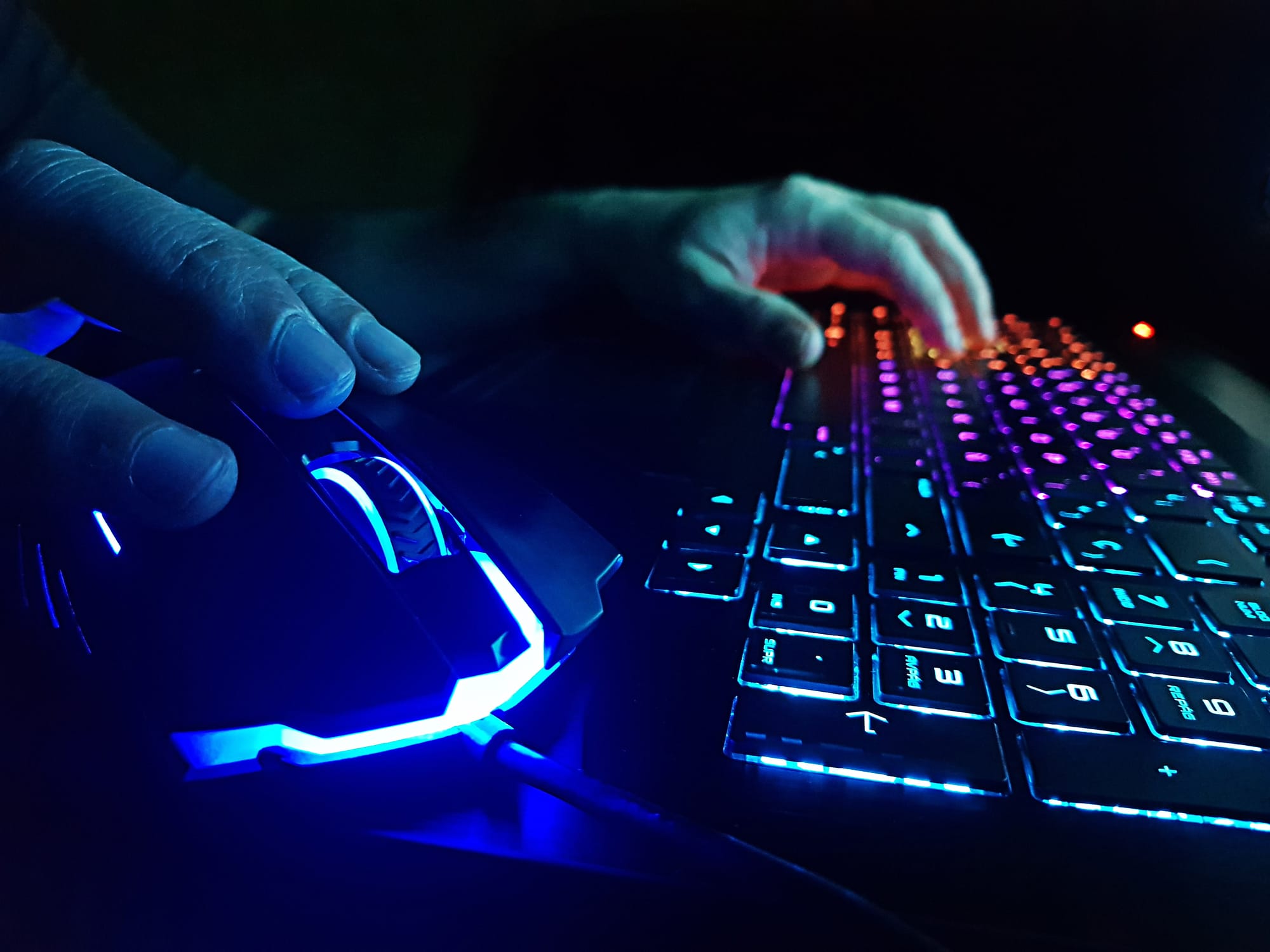 Image of a person's hands on a keyboard and mouse