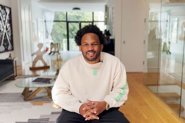 Kickstarter CEO, Everette Taylor, seated in a living room, smiling towards the camera