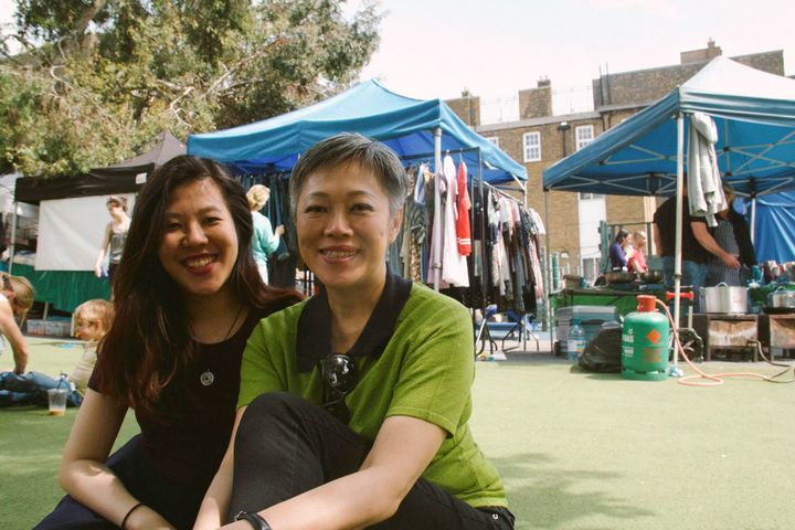 Two Asian women, one with straight hair in her early 20s, the other an elegant woman with grey cropped hair in her early 50s.