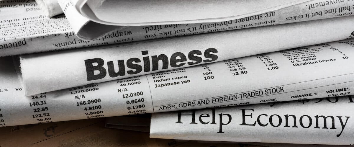 Stack of newspapers showing the Business section