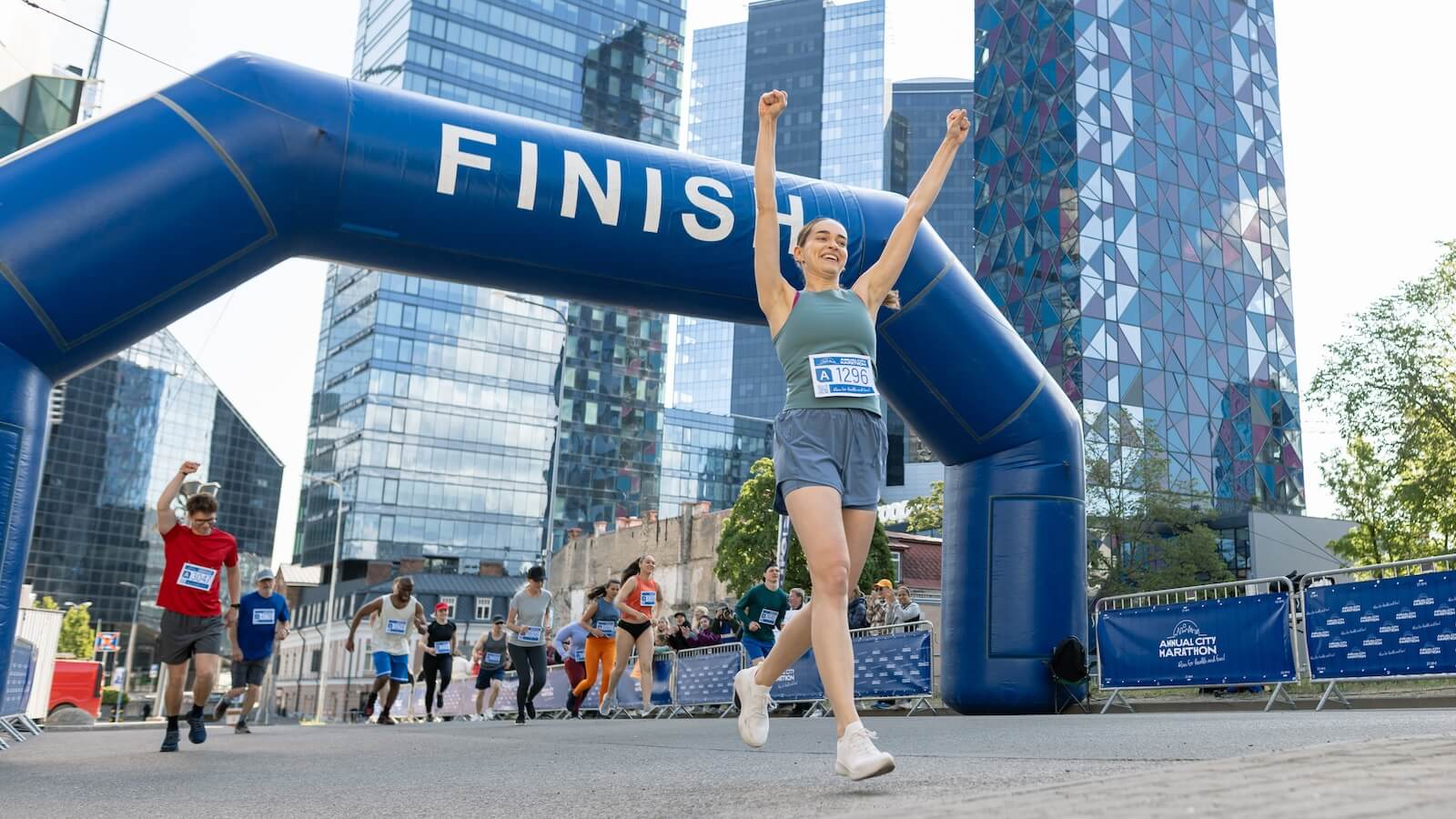 Young woman crossing a marathon finish line