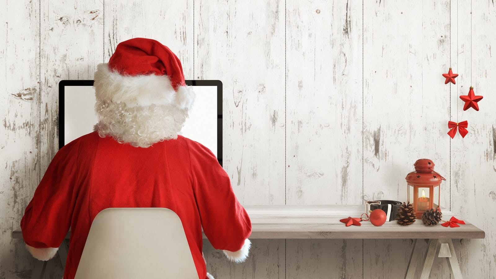 Image of Santa sitting in front of a computer