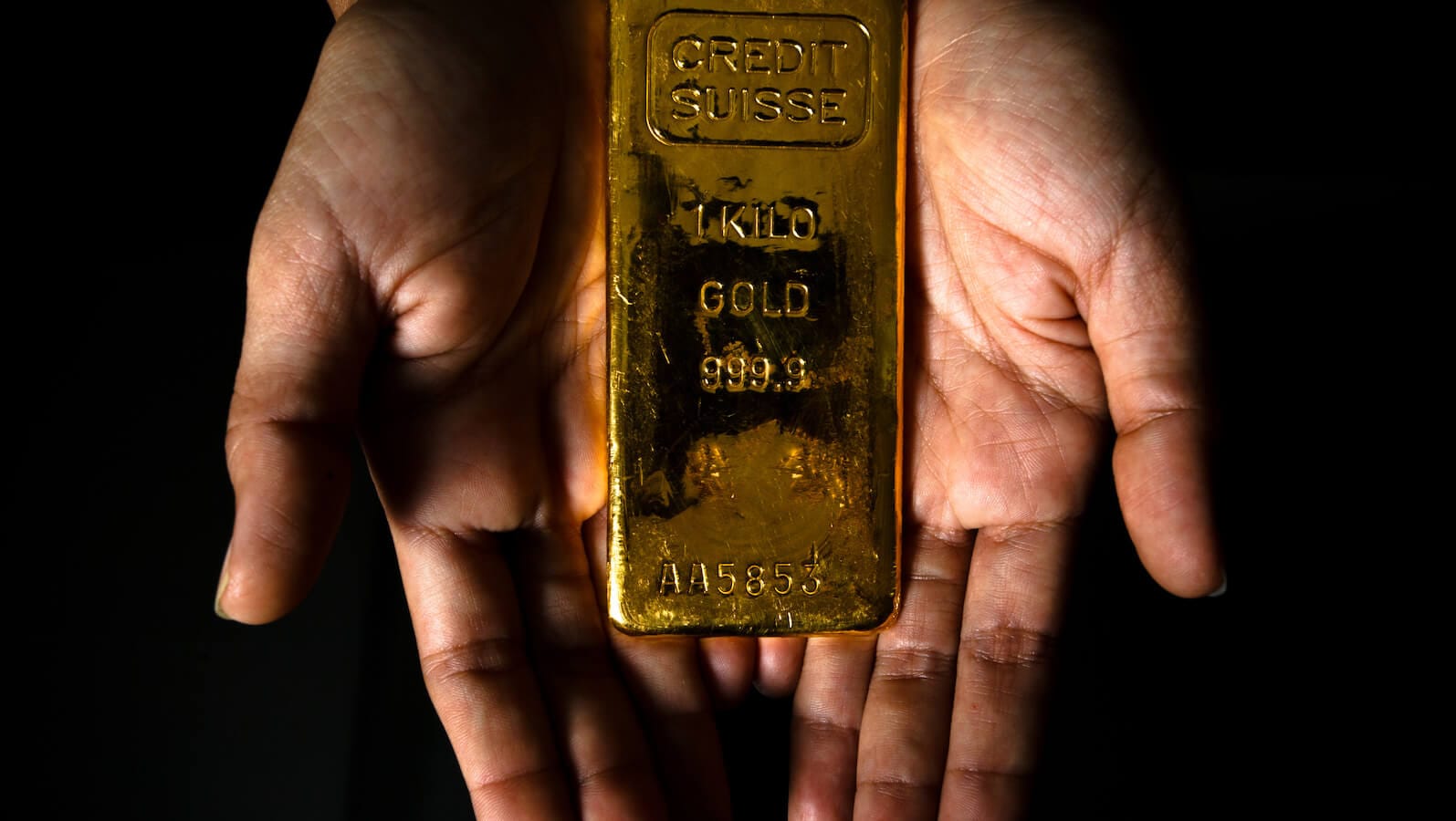 Gold bar in a person's hands