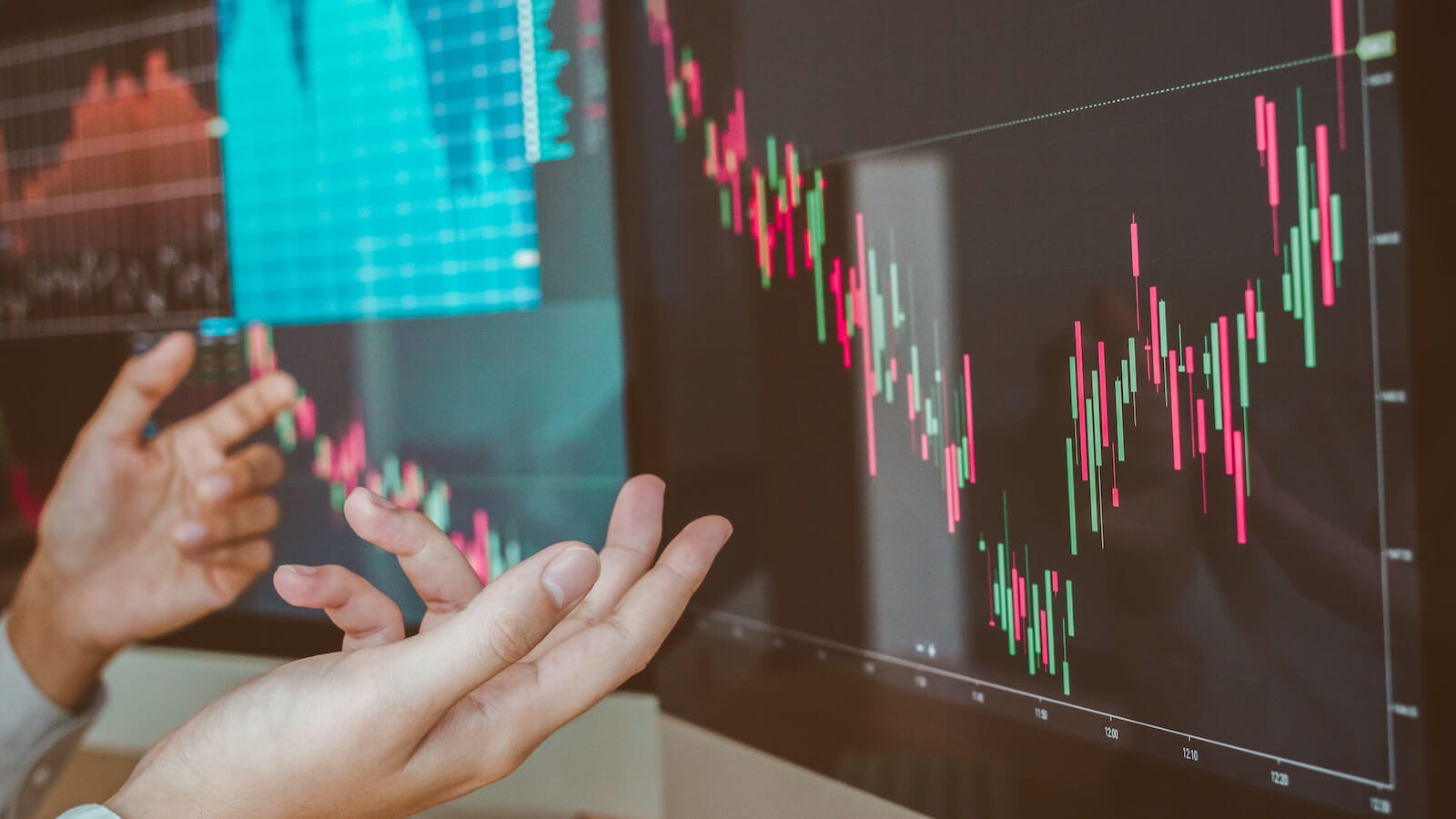 Person looking at chart and gesturing uncertainty with hands