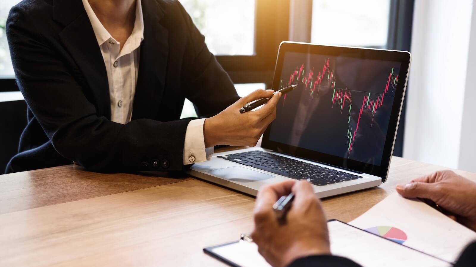 Person showing economic charts on laptop