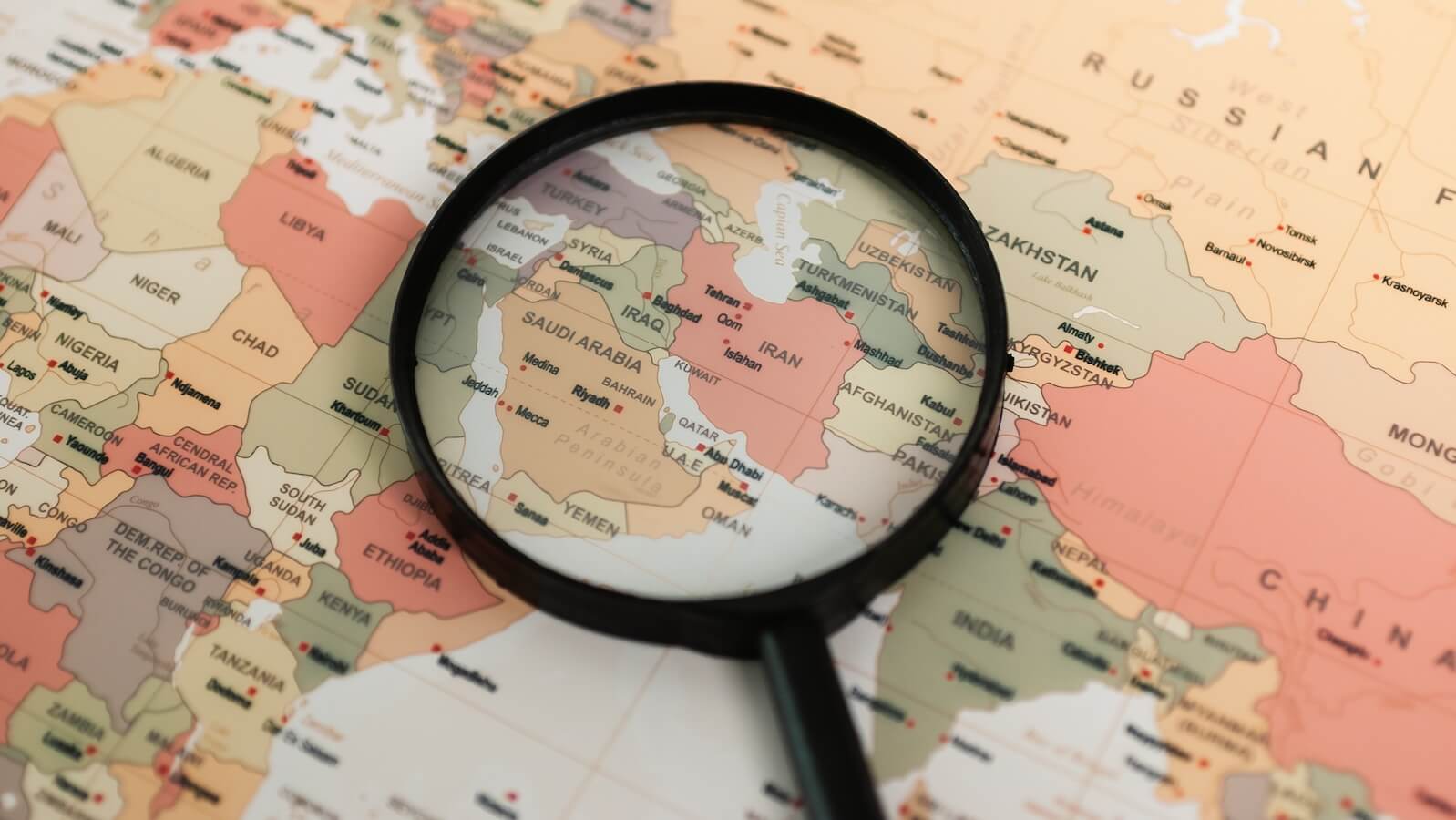 Map focusing on middle east with magnifying glass: Gulf Country ETFs Forecast