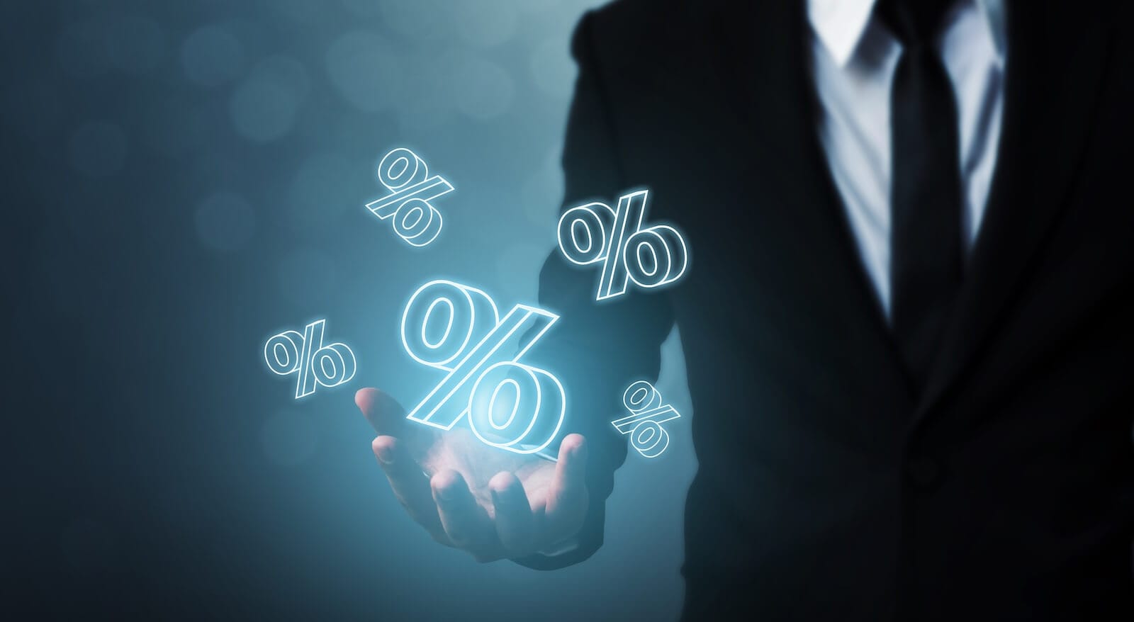 Person in suit juggling percentage signs: 5% Treasury Yield
