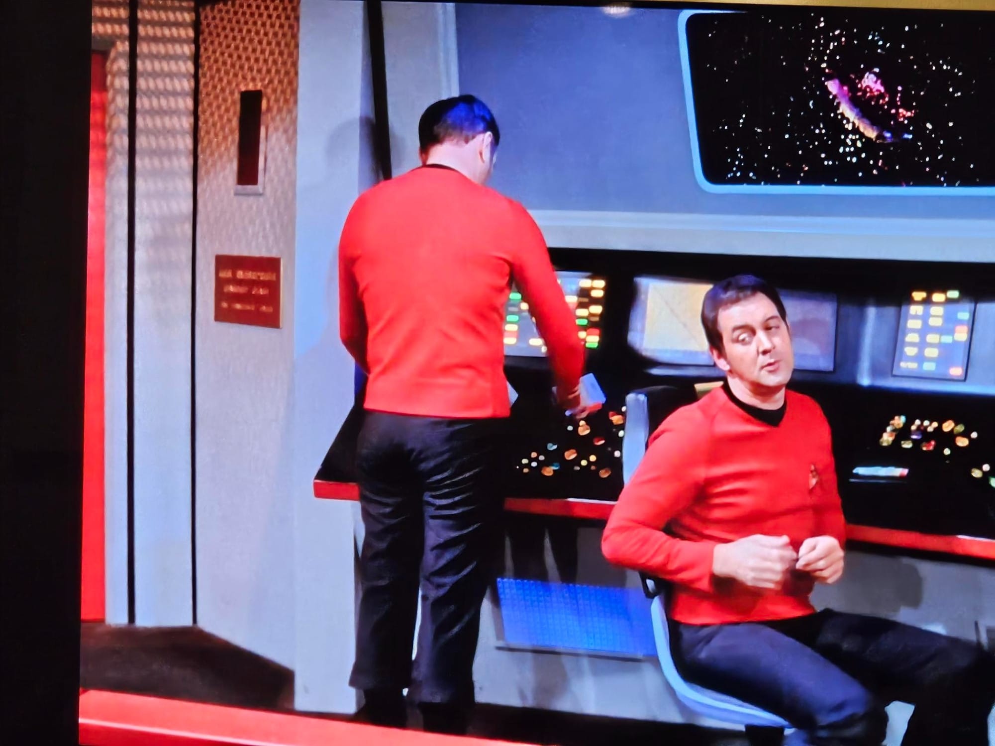 A dorky redshirt on the bridge of the Starship Enterprise, dorkily rocking out to space hippie music.