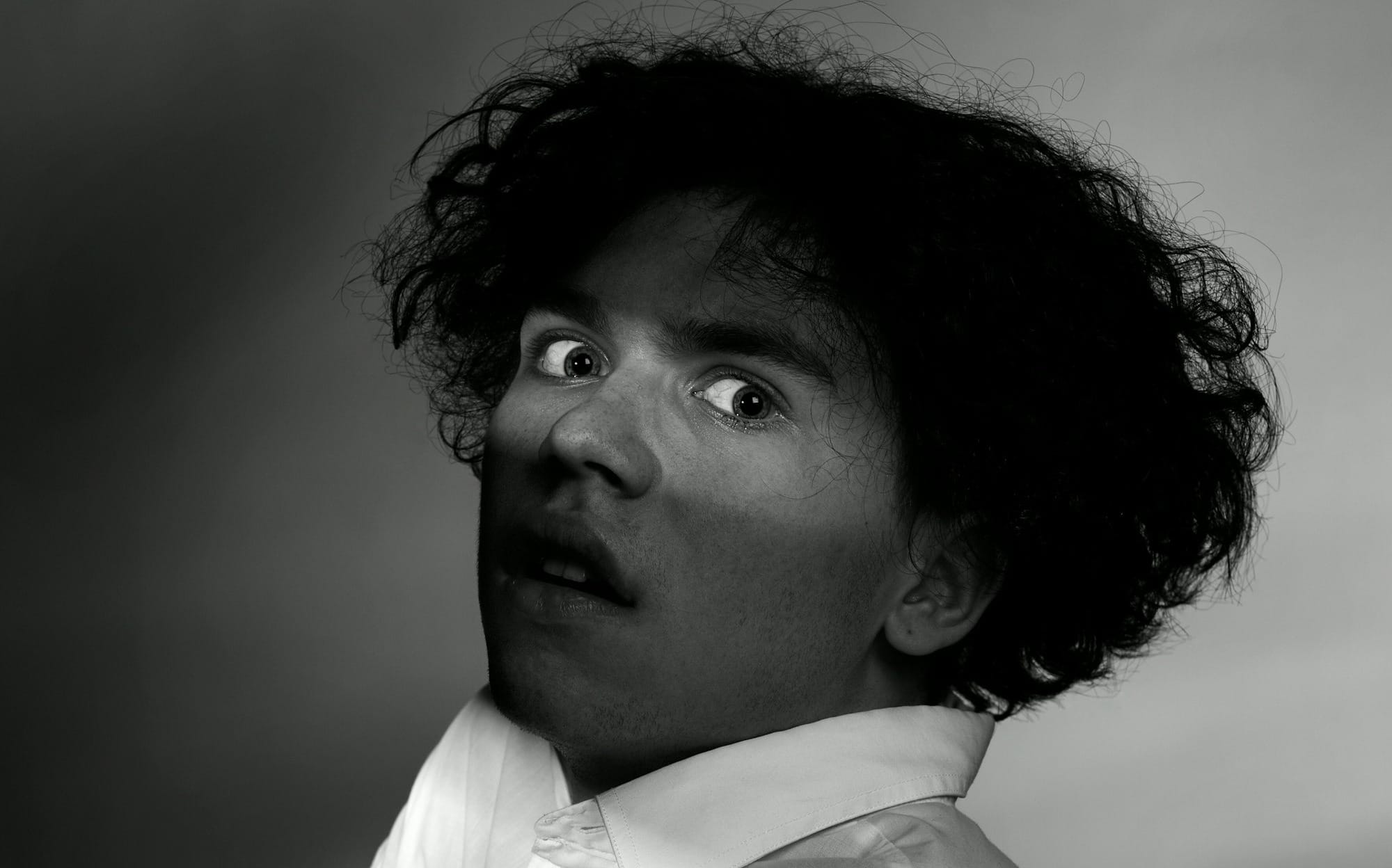 a black and white photo of a man with his arms crossed